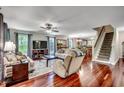 Spacious living room featuring gleaming hardwood floors, comfortable seating, and abundant natural light at 5113 Pee Dee Ln., Murrells Inlet, SC 29576