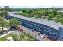 Aerial view showcases the building's structure, parking lot, and surrounding lush trees, with a glimpse of the ocean at 5905 South Kings Hwy. # 5202, Myrtle Beach, SC 29575
