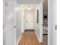 Bright hallway featuring wood floors, white walls, and views into the bedroom and entryway at 5905 South Kings Hwy. # A518, Myrtle Beach, SC 29575