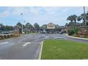 The Ocean Lakes Community entrance has a large sign, palm trees, and well maintained grounds at 6001 S Kings Hwy., Myrtle Beach, SC 29575