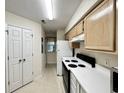 Functional kitchen featuring white appliances, light cabinets, and ample counter space at 665 Tupelo Ln. # 17-D, Longs, SC 29568