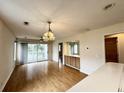 Open-concept living room with wood floors, lots of light, and access to a balcony at 665 Tupelo Ln. # 17-D, Longs, SC 29568