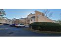 Exterior view of condos with multi-level balconies surrounded by manicured landscaping, and ample parking at 1025 W Plantation Dr. W # 2817, Little River, SC 29566