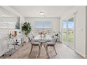 Bright dining area with glass-top table, modern chairs, and sliding glass door at 1031 Corn Husk Loop, Conway, SC 29527