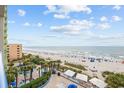 Gorgeous beach view shows a sandy beach, clear blue water, and an outdoor pool at 1105 S Ocean Blvd. # 520, Myrtle Beach, SC 29577