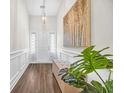 Bright foyer with hardwood floors, wainscoting, art, and a bench at 116 Glengrove Lane, Murrells Inlet, SC 29576
