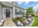 Front yard features rock garden with greenery, white sphere accents, and seating area at 116 Glengrove Lane, Murrells Inlet, SC 29576