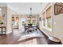 Another view of the open dining area with large windows, woven blinds, and hardwood floors at 1210 East Isle Of Palms Ave., Myrtle Beach, SC 29579