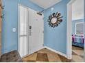 Bright entryway with stylish mirror and blue accent wall, leading into the bedroom at 135 S Dunes Dr. # 501, Pawleys Island, SC 29585