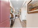 Elegant entryway with wood flooring, decorative mirrors, and a view into the dining area at 171 Cassina Dr., Longs, SC 29568