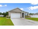 Well-maintained home showcasing a large driveway, charming siding, and an attached two-car garage at 171 Cassina Dr., Longs, SC 29568
