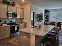 Modern kitchen featuring granite countertops, stainless steel appliances, and an island with seating at 171 Cassina Dr., Longs, SC 29568