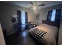 Cozy bedroom featuring neutral tones, a ceiling fan, dark curtains, and a large platform bed at 1903 Rose St., Conway, SC 29527