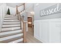Inviting foyer with wooden stairs, white risers, and an adjacent wall adorned with decorative wood trim at 201 West Isle Of Palms Ave., Myrtle Beach, SC 29579