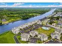 Aerial view of waterfront condominiums showing community pool, boat docks, landscaping, and surrounding wooded area at 222 Landing Rd. # 1811, North Myrtle Beach, SC 29582