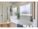 Relaxing bathroom featuring a soaking tub, separate shower and frosted window for privacy at 227 Sundrop Way, Conway, SC 29526