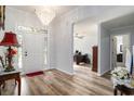 Inviting foyer boasts stylish wood floors and a stunning chandelier at 2981 Victor Rd., Longs, SC 29568