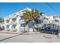 Multi-level condominium building offering balconies, stairwells, and a convenient parking area for residents and guests at 300 47Th Ave. S # 1F, North Myrtle Beach, SC 29582