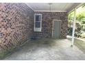 Spacious carport featuring brick walls and concrete flooring at 41 Harmon St., Hemingway, SC 29554