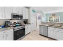 Modern kitchen featuring stainless steel appliances, granite countertops, and bright white cabinetry at 411 Mahogany Dr. # 101, Murrells Inlet, SC 29576