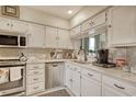 Well-maintained kitchen with stainless steel appliances, sleek white cabinets, and attractive marble backsplash at 4396 Baldwin Ave. # 1, Little River, SC 29566