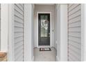 Close-up of a home's welcoming front door with decorative wreath and charming 'HOME' door decor at 462 Pacific Commons Dr., Surfside Beach, SC 29575