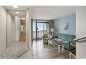 Living room with sofa, chair and table, access to balcony and ocean views at 4800 S Ocean Blvd. # 1221, North Myrtle Beach, SC 29582