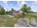 A single-story brick home with an overgrown yard and dilapidated surroundings at 4860 Highway 378, Conway, SC 29527