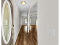 Inviting entryway with hardwood floors, arched doorways, and natural light creating a seamless flow to the living area at 5115 Huston Rd., Conway, SC 29526