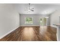 Bright open-plan living room with vaulted ceiling, hardwood floors, fan, and sliding doors leading to the outside at 5115 Huston Rd., Conway, SC 29526