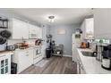 Bright kitchen featuring white cabinets, neutral countertops, and modern appliances at 517 Cardinal Dr., Conway, SC 29526