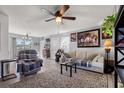 Cozy living room featuring neutral paint, natural light, ceiling fan, and comfortable furnishings at 517 Cardinal Dr., Conway, SC 29526