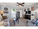 Comfortable living room featuring light gray walls, ceiling fan, and entertainment center with fireplace at 517 Cardinal Dr., Conway, SC 29526