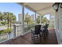 Charming porch featuring classic columns and comfortable outdoor seating, beach view at 5407 N Ocean Blvd., Myrtle Beach, SC 29577