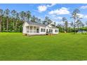 Charming single-story home with a covered porch and a large, well-manicured lawn at 565 Kent Rd., Georgetown, SC 29440