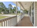 Inviting covered front porch with wooden floors, offering a relaxing outdoor space at 568 Rosedale Dr., Aynor, SC 29511