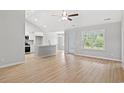 Bright open-concept living area with vinyl plank flooring, high ceilings, and access to kitchen at 600 Woodside Dr., Conway, SC 29526
