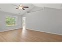Inviting living room with large window, vaulted ceiling, and plank flooring at 600 Woodside Dr., Conway, SC 29526