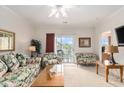 Cozy living room with bright lighting, ceiling fan, and access to balcony at 604 Heathrow Dr. # 1101, Myrtle Beach, SC 29579
