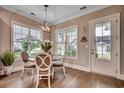 Dining area with a chandelier and a round table with seating, and abundant natural light from the windows at 620 Lorenzo Dr. # 620, North Myrtle Beach, SC 29582