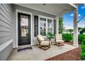 Inviting front porch featuring a seating area with two chairs and a plant, creating a cozy and welcoming entrance at 620 Lorenzo Dr. # 620, North Myrtle Beach, SC 29582
