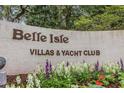 Belle Isle Villas & Yacht Club sign surrounded by colorful flowers and lush greenery at 64 Bamboo Loop # 161, Georgetown, SC 29440
