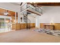 Spacious living room featuring a unique spiral staircase and soaring wood ceilings at 6593 Sunshine St. Nw, Ocean Isle Beach, NC 28469