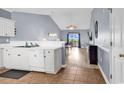 Open kitchen featuring white cabinets and appliances seamlessly flowing into a living area at 701 Salleyport Dr. # 1117, Myrtle Beach, SC 29579