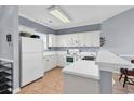 Eat-in kitchen with white appliances, countertop seating and tiled flooring at 701 Salleyport Dr. # 1117, Myrtle Beach, SC 29579