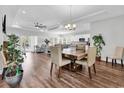 Open-concept dining area with a wooden table, chairs, and view of the living room at 7377 Pauley Swamp Rd., Conway, SC 29527