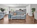 Open-concept living area featuring hardwood floors, a comfortable couch, and a view into the kitchen at 7377 Pauley Swamp Rd., Conway, SC 29527