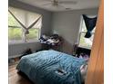 Bedroom with carpeted floors, two windows, and a closet; needs TLC at 7708 Woodland Dr., Myrtle Beach, SC 29572