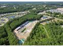 An aerial view of the community of townhomes near a pond surrounded by lush trees at 786 Nw Palm Frond Way # 51, Calabash, NC 28467