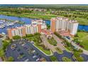 Picturesque aerial view of a luxurious resort with waterway access, showcasing its multiple buildings, parking, and golf course at 8121 Amalfi Pl. # 4706, Myrtle Beach, SC 29572